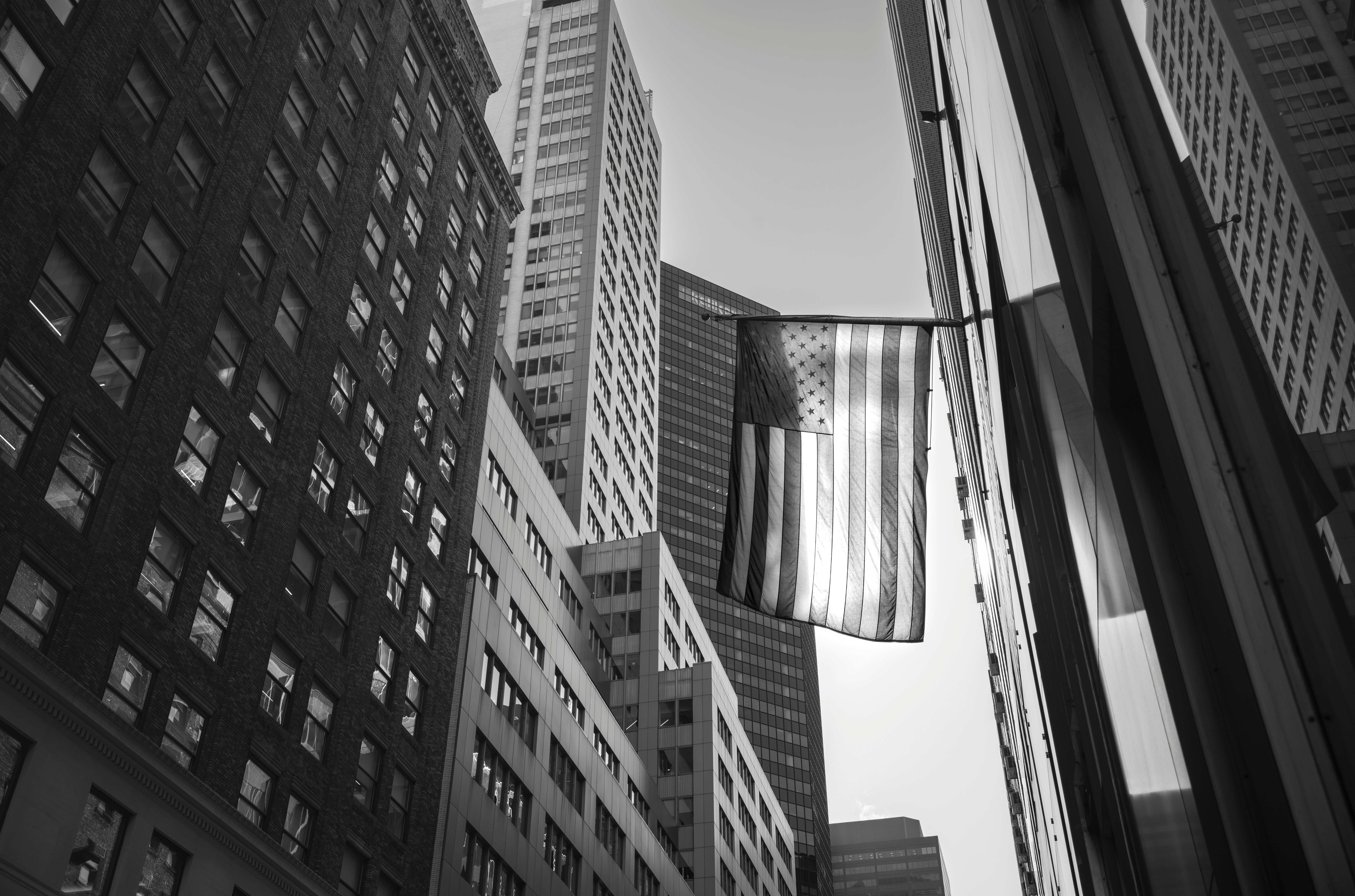 American flag among city skyscrapers